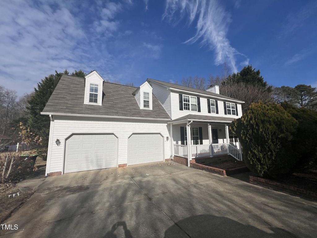 view of front facade with a garage and covered porch