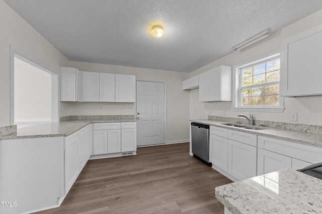 kitchen with dishwasher, a sink, and white cabinetry