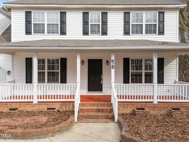 view of front of property with a porch, crawl space, and a shingled roof