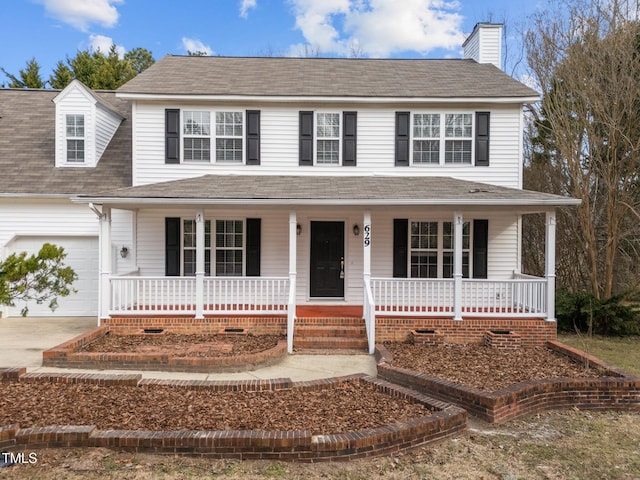 view of front of property featuring covered porch, driveway, a chimney, and an attached garage