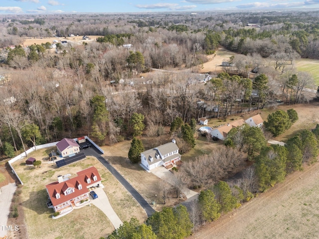 birds eye view of property with a view of trees