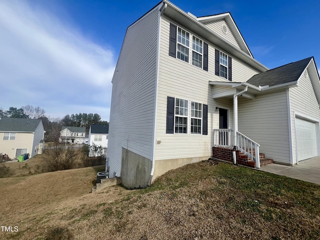 view of front of home with a front yard and a garage