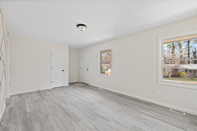 spare room with light hardwood / wood-style flooring