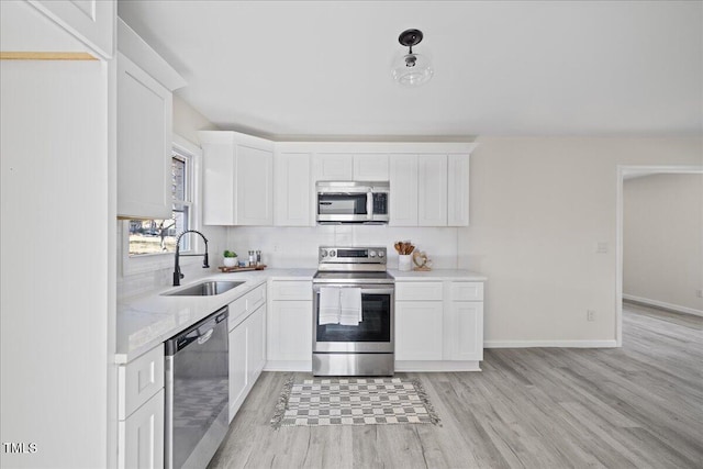 kitchen featuring white cabinets, stainless steel appliances, and sink