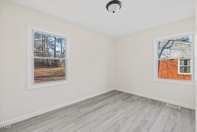 unfurnished room with light hardwood / wood-style flooring