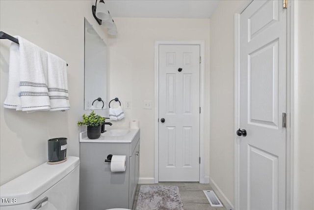 bathroom featuring hardwood / wood-style flooring, vanity, and toilet