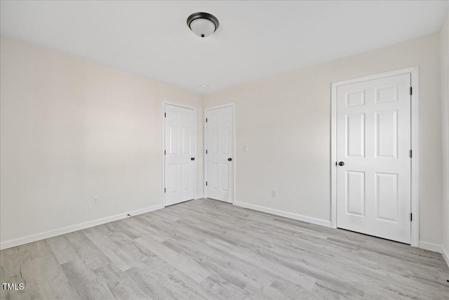 unfurnished bedroom with light wood-type flooring