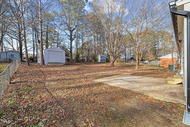 view of yard with a patio, cooling unit, and a storage unit