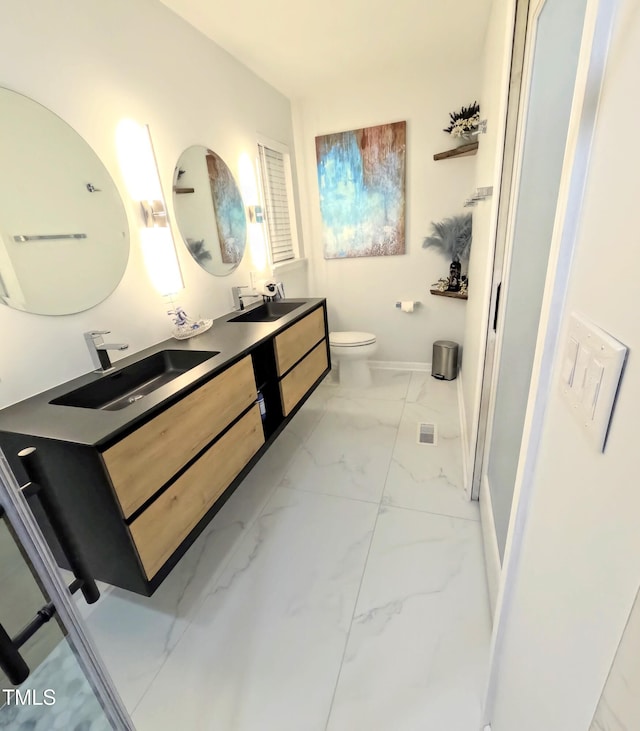 bathroom featuring toilet and vanity