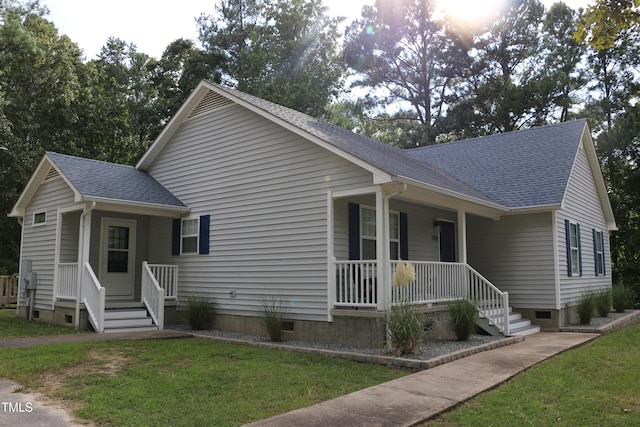 view of front of property with covered porch and a front yard