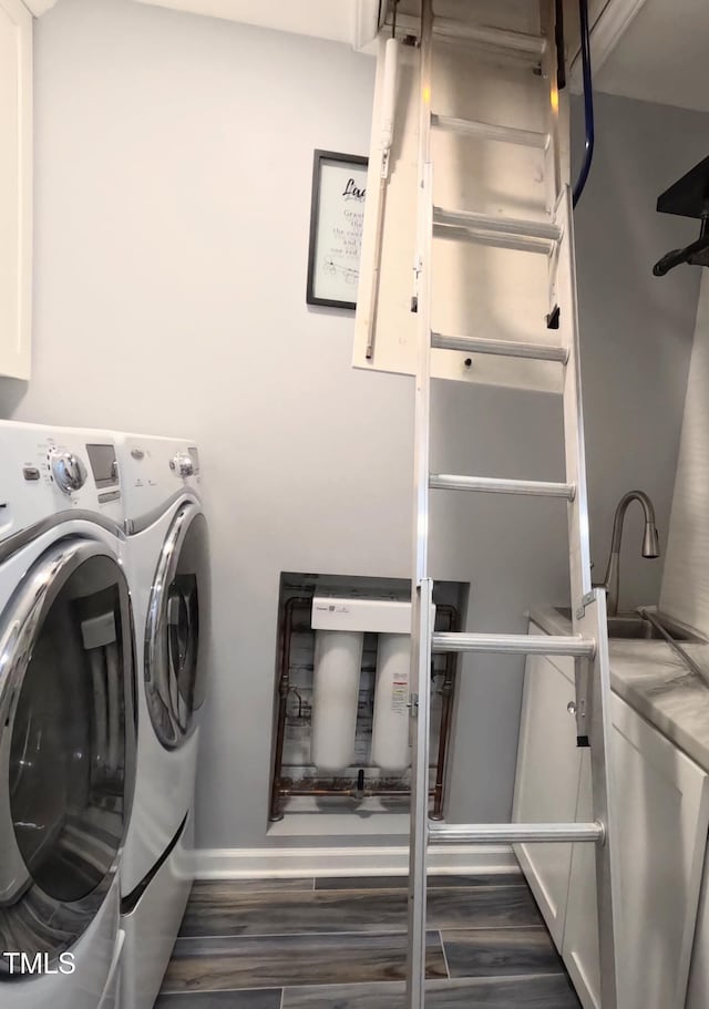 washroom featuring dark hardwood / wood-style flooring and washer and dryer