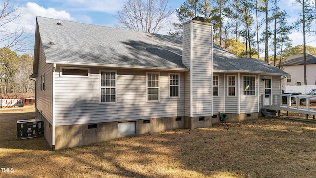 back of house featuring a yard and central AC