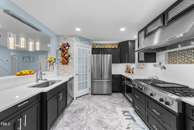 kitchen with ventilation hood, stainless steel appliances, decorative backsplash, decorative light fixtures, and sink