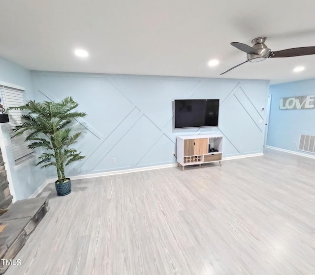 unfurnished living room featuring ceiling fan and wood-type flooring