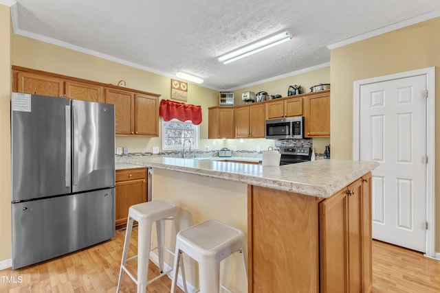 kitchen with ornamental molding, a textured ceiling, tasteful backsplash, a kitchen island, and stainless steel appliances