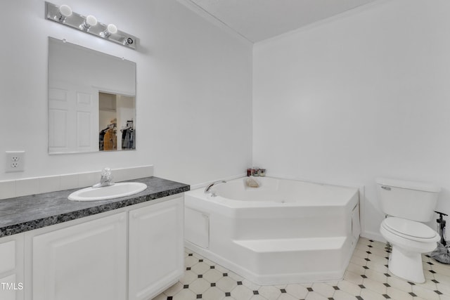 bathroom with vanity, a bath, and toilet