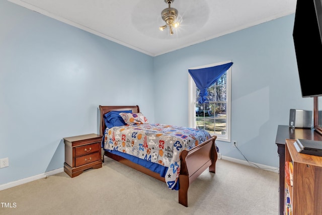 carpeted bedroom with ceiling fan and ornamental molding