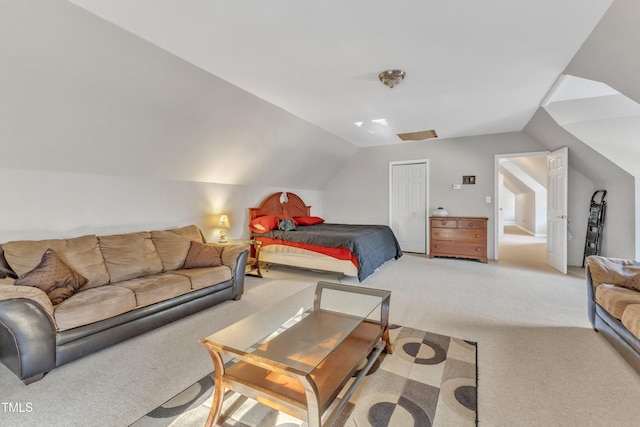 carpeted bedroom with vaulted ceiling and a closet