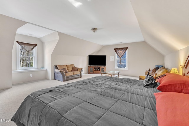 bedroom with carpet floors and lofted ceiling