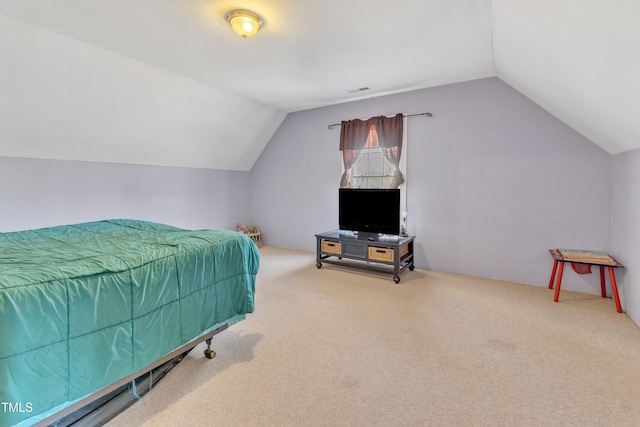 bedroom featuring carpet floors and vaulted ceiling