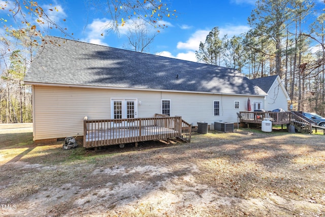 rear view of house with cooling unit and a deck