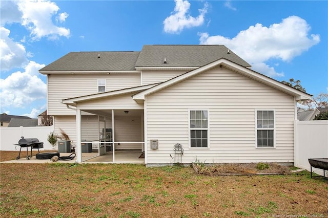 back of property featuring a patio, central air condition unit, and a lawn