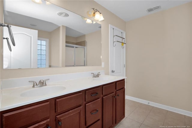 bathroom with tile patterned floors, vanity, and walk in shower