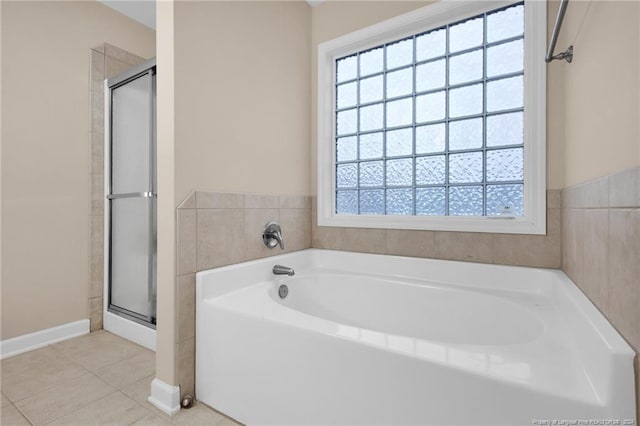 bathroom featuring plus walk in shower and tile patterned floors