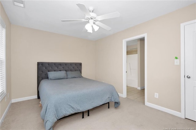 bedroom with ceiling fan and light colored carpet