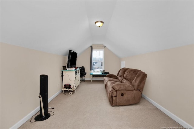 sitting room with light colored carpet and lofted ceiling