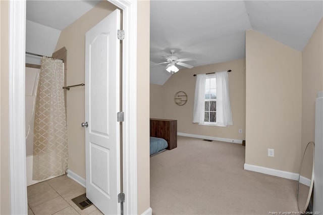 bathroom featuring ceiling fan, shower / tub combo with curtain, and vaulted ceiling