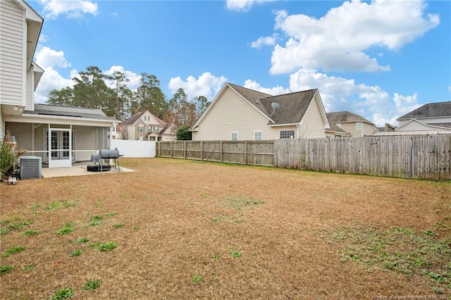 view of yard with central AC unit and a patio area