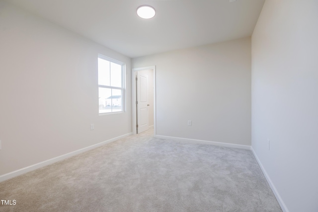 spare room with light colored carpet