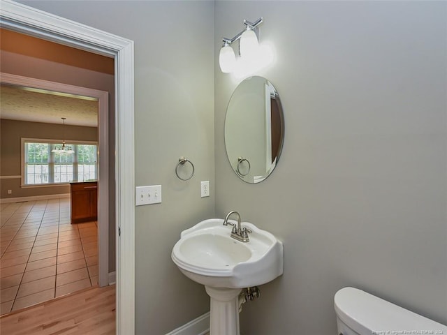 bathroom with hardwood / wood-style floors and toilet