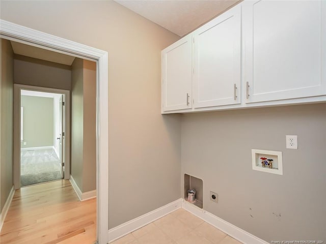 washroom with washer hookup, electric dryer hookup, and cabinets