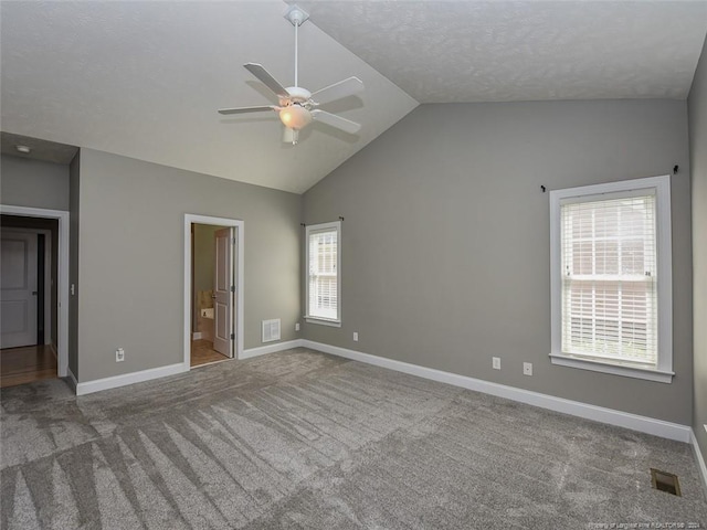 unfurnished bedroom featuring ensuite bath, ceiling fan, carpet, and multiple windows