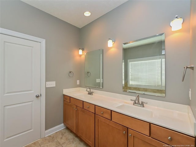 bathroom with tile patterned floors and vanity