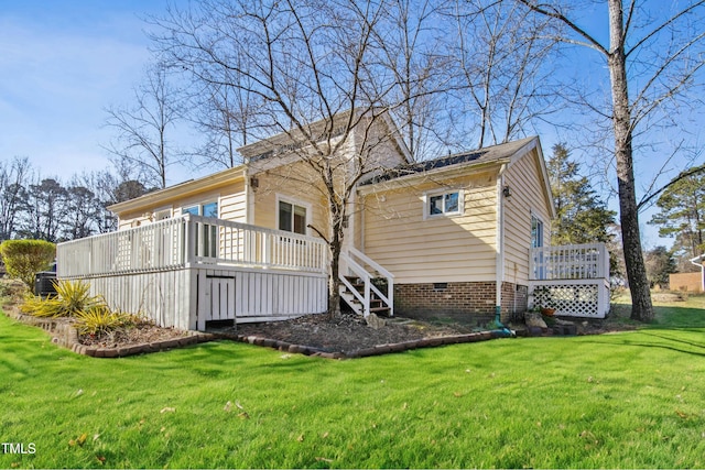 rear view of property with a yard and a deck