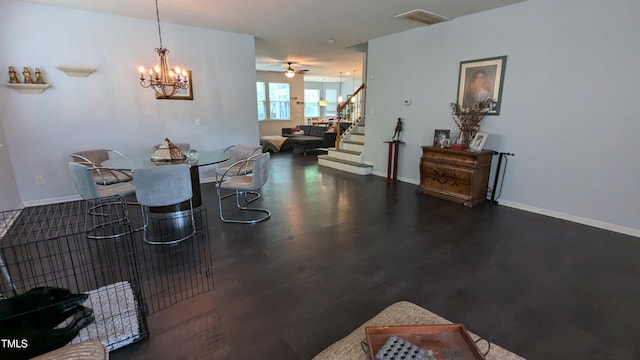 dining room featuring ceiling fan with notable chandelier