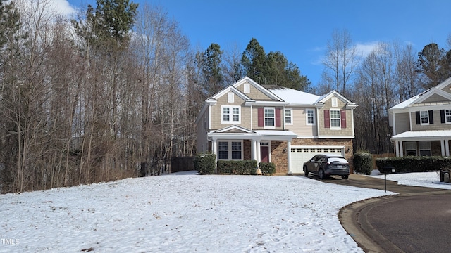 view of front of house with stone siding, driveway, and an attached garage