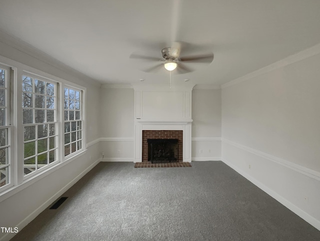 unfurnished living room with ceiling fan, ornamental molding, a fireplace, and carpet floors