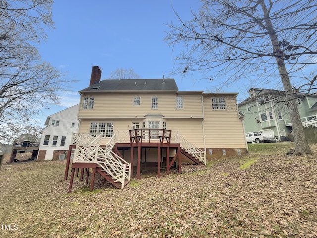 rear view of property with a wooden deck