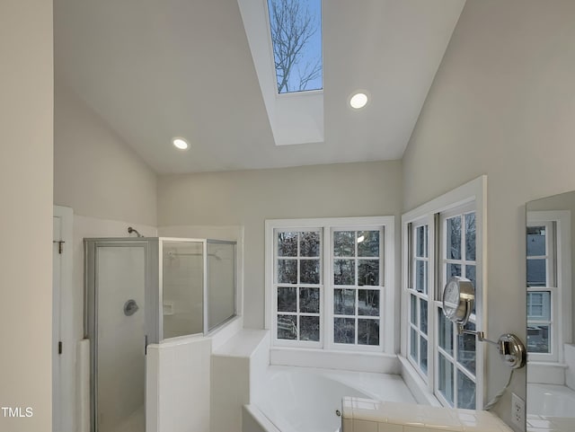 bathroom featuring separate shower and tub and lofted ceiling with skylight