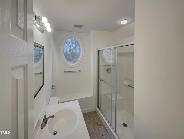 bathroom featuring tile patterned flooring, a shower with door, and sink