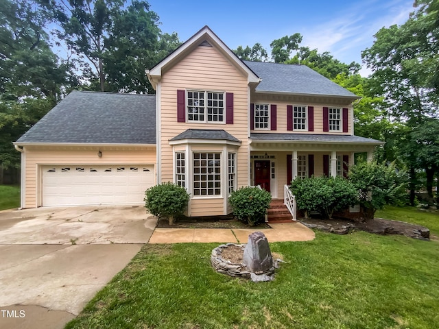 113 Crosswind Dr, Cary, NC 27513 - traditional-style house featuring concrete driveway, a garage, a front lawn, and covered porch