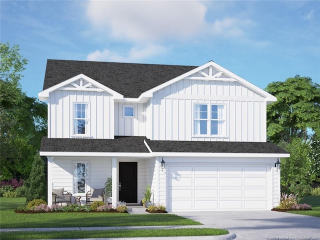 view of front of property featuring a front yard and a garage