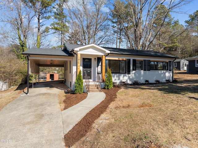 ranch-style home with a carport and a front yard