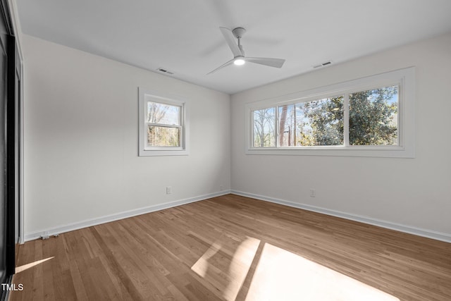 unfurnished room with hardwood / wood-style floors and ceiling fan