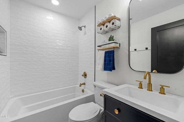 full bathroom featuring vanity, tiled shower / bath combo, and toilet