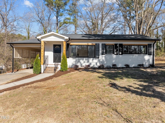 ranch-style home featuring a front yard and a carport